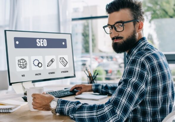 imgi_22_young-successful-seo-manager-sitting-at-workplace-2024-11-19-18-44-40-utc-1