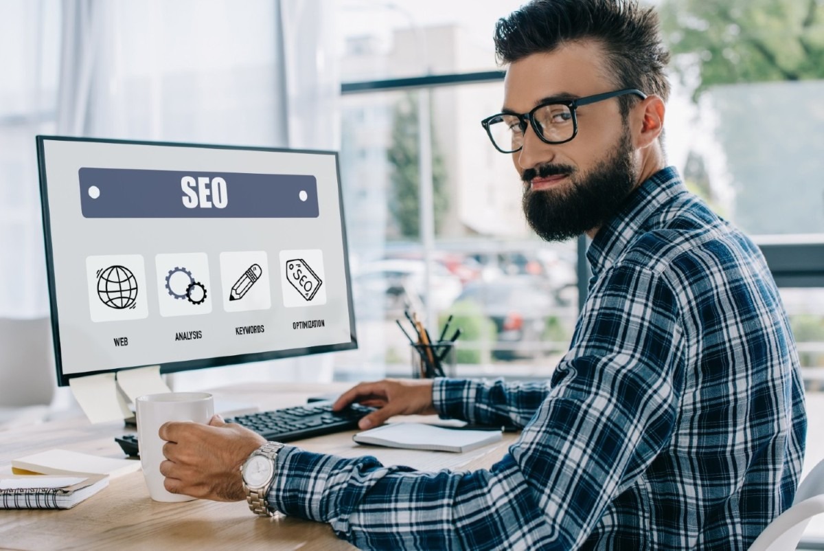 imgi_22_young-successful-seo-manager-sitting-at-workplace-2024-11-19-18-44-40-utc-1